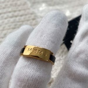 Marc By Marc Jacobs logo gold and back ring (Size 7)
